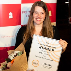 Rebecca Higgie holding winner certificate and bunch of flowers
